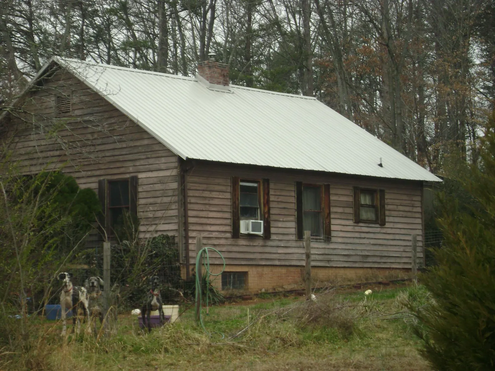 White metal roof on an old wood sided farmhouse, from a Metal Roof Installation job in Elkhart